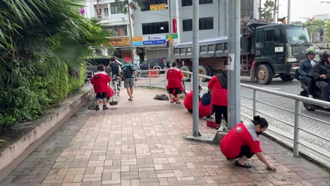 Escena-De-Un-Grupo-De-Limpiadores-Barriendo-El-Piso,-Limpiando-Basura-Y-Recogiendo-Escombros-Y-Hojas-En-El-Pavimento-En-Johor-Bahru,-Malasia