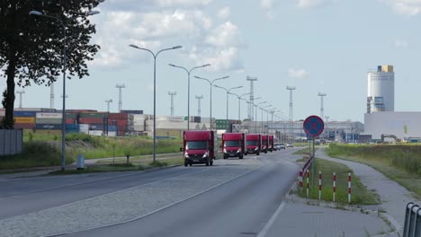 Flotte-Von-HSM-Global-Lieferwagen-Fahren-Hintereinander-Auf-Der-Straße-Am-Stadtrand
