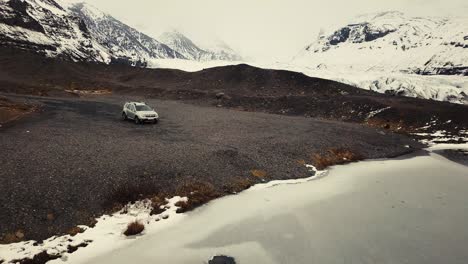 Coche-Solitario-Junto-A-Un-Pequeño-Lago-Y-Un-Glaciar-Gigante-En-El-Fondo