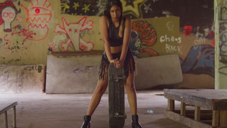 A-young-female-skateboarder-in-a-mini-skirt-navigates-through-an-indoor-skate-park