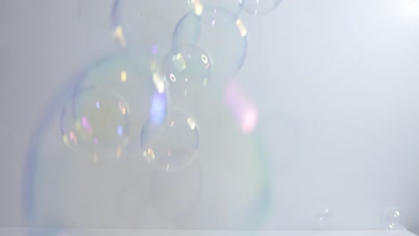 Clear-Bubbles-falling-in-front-of-white-background