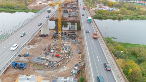 New-bridge-being-constructed-over-Neris-river,-aerial-drone-view