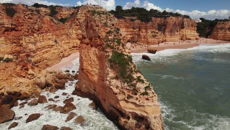 Coastline-circle-view-with-beautiful-orange-rugged-cliffs-by-aerial-4k-drone-at-Estrada-da-Caramujeira-in-the-Algarve-region-of-Portugal