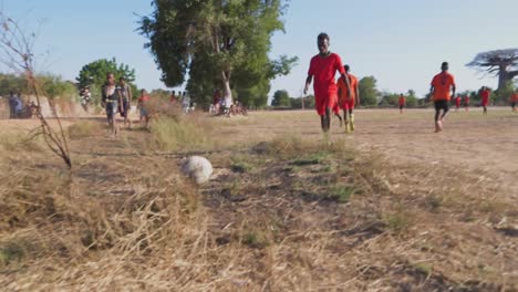 Men-dribbling-in-football-game-among-baobabs-in-rural-Madagascar