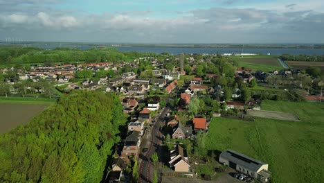 Aerial-footage-of-the-village-of-Moerdijk-in-the-Netherlands-with-a-tall-clock-tower-in-the-center