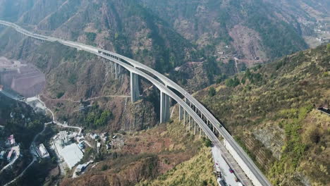 Side-View-Of-Trucks-Cars-Vehicles-Passing-Double-Lane-Highway-Bridge-In-The-Mountains-Motorway