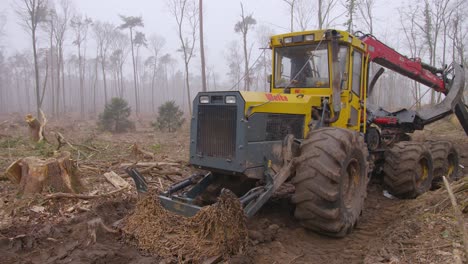 A-slider-shot-of-a-tree-excavator-in-the-middle-of-a-destroyed-forest