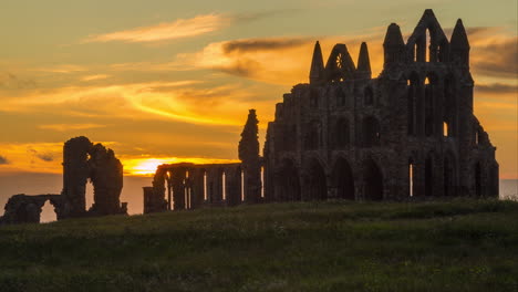 Whitby-Abbey-timelpase-taken-from-outside-of-the-NT-grounds,-sunset-through-to-dusk-and-Abbey-Silhouette