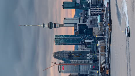 Vertical-day-to-night-timelapse-of-Sky-Tower-Auckland,-New-Zealand-skyline