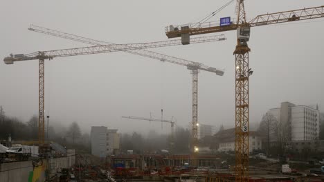 It-is-busy-on-a-foggy-day-and-the-3-cranes-swing-to-new-positions-at-the-same-time