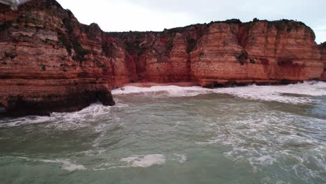 Coastline-circle-view-with-rugged-cliffs-by-aerial-4k-drone-at-Ponta-da-Piedade-near-Lagos-in-the-Algarve-region-of-Portugal