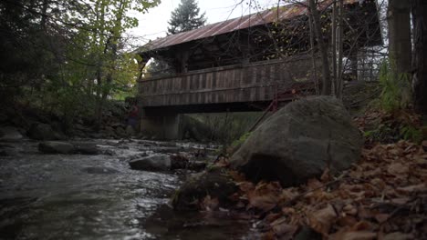 Cullen-Gardens-Central-Park-in-Whitby-with-Low-Panning-Angle-Along-River-with-Autumn-Fall-Leaves-and-Footbridge-in-Background,-Canada