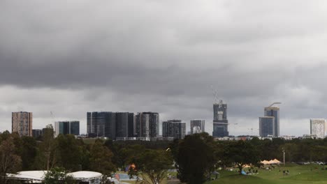 Timelapse-of-cloudy-overcast-cityscape-and-park-at-Sydney-Olympic-Park,-NSW-Australia