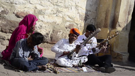 Traditional-Folk-young-boy-singer-signing-song-performing-playing-violin-in-public-with-his-family-daylight-outdoor-front-view