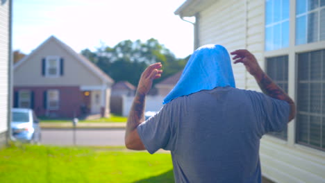 Adult-male-cooling-off-in-the-shade-walking-toward-vehicle-outside,-behind