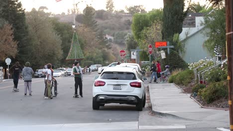 kids-wait-in-the-street-as-they-watch-their-friend-mess-up-his-skateboard-trick