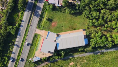 Aerial-view-rooftop-of-Mitsubishi-car-showroom-near-the-main-road-Khon-Kaen,-Thailand