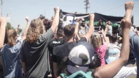 Diverse-Crowd-of-Protestors-Put-Fists-in-the-Air,-Slow-Motion