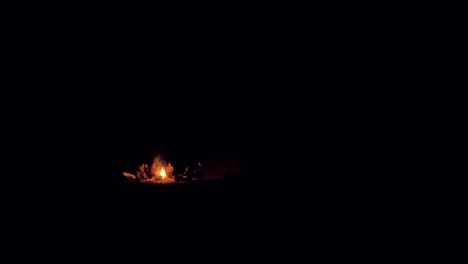 Wide-angle-view-of-people-sitting-around-a-campfire-and-enjoying-a-summer-evening-outside-in-the-Magdalen-Islands