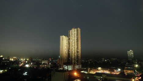 A-view-of-tall-building-in-the-middle-of-city-with-stars-movang-the-background