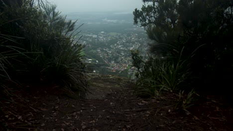 Reveal-eerie-cliff-edge-with-distant-town