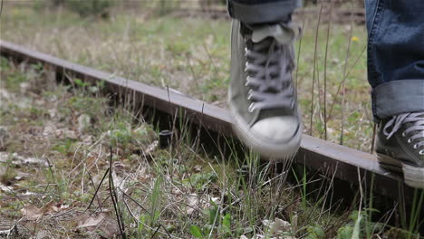 Feet-walking-on-old-train-track