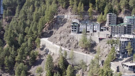 mountainous-resort-area-with-contemporary-buildings-on-a-rugged-hillside,-surrounded-by-coniferous-forest