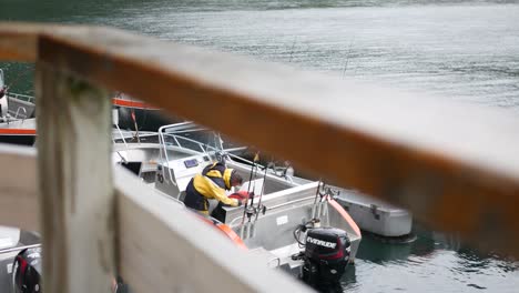 Fisherman-on-moored-boat-prepares-to-leave-to-go-fishing