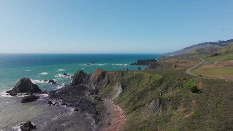 Cinematic-drone-shot-flying-over-a-coastal-highway-in-the-pacific-northwest