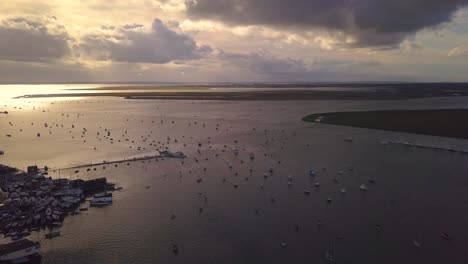 Aerial-of-Fishing-town-in-the-UK,-West-Mersea,-British-Coast,-Tracking-Reverse-wide-shot