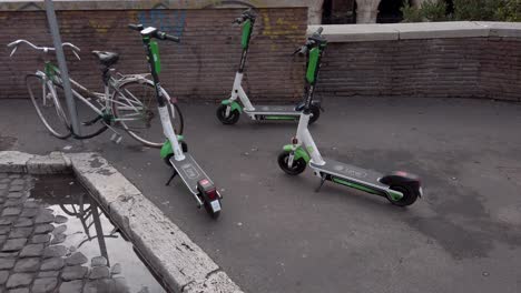 Dockless-e-scooters-blocking-the-pavement-in-front-of-the-colosseum-in-Rome,-Italy