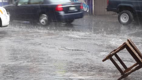 Old-woman-carrying-a-chair-under-heavy-rain-in-Mexico-City