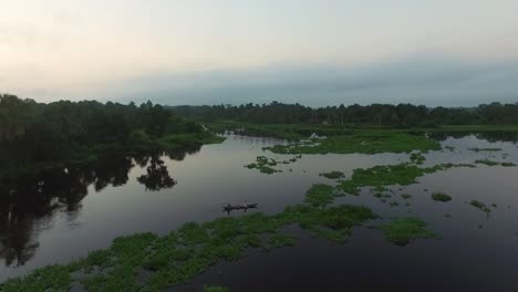 AERIAL-Orinoco-Delta,-Two-People-In-A-Canoe-Paddling