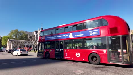 Sunny-day-in-London-with-traffic-along-Parliament-Street-near-Parliament-Square,-showcasing-dynamic-urban-life