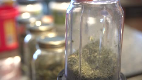 Homemade-Cannabis-Oil---Dried-Marijuana-Buds-And-Leaves-Finely-Ground-On-The-Food-Processor---close-up-shot