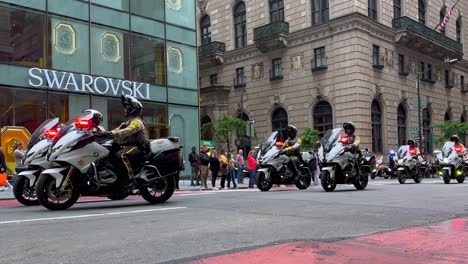 A-low-angle-shot-of-a-parade-of-motorcycle-police-officers-from-various-states,-riding-down-Fifth-Avenue-on-a-cloudy-day-in-New-York