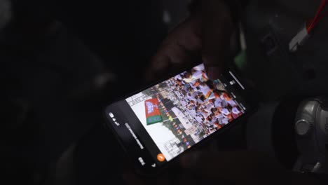 Indian-journalist-and-photographer-swiping-through-his-mobile-after-clicking-photographs-during-Lok-Sabha-election-campaign-by-BJP