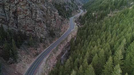 Panning-up-shot-of-an-empty-canyon-road,-up-Big-Cottonwood-Canyon,-Utah