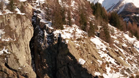 Aerial-of-rocky-mountain-cliff-in-winter