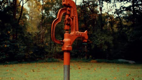 Slow-motion-shot-of-water-pouring-out-of-a-freezeless-yard-hydrant