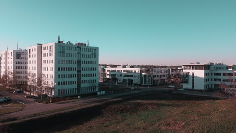 Flying-over-a-technology-park-with-office-buildings-in-central-europe-in-times-of-a-lockdown-while-sun-is-setting