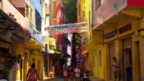 The-narrow-streets-of-the-colorful-favela-with-people-walking-about