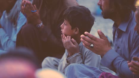 Closeup-view-of-innocent-Pakistani-boy-praying-before-having-their-Iftar-in-Balochistan,-Pakistan