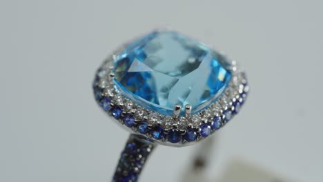 Blue-gemstone-on-a-rotating-ring-with-diamonds