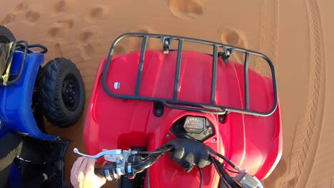 Pov-getting-on-a-quad-on-a-desert-in-Morocco,-on-a-sunny-evening