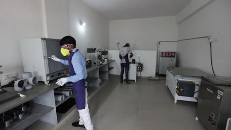 pov-shot-of-two-men-undergoing-chemical-processing-in-different-systematic-ways