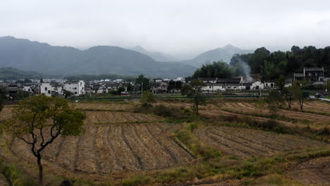 Hongcun-traditional-remote-Chinese-town,-surrounded-by-agricultural-farmland