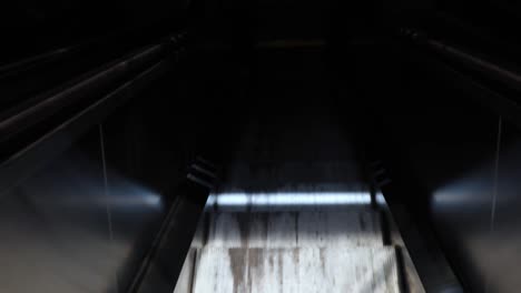 Riding-an-escalator-down-into-a-shopping-mall-parking-lot,-Hawaii