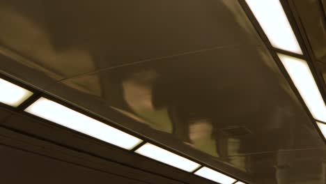 train-ceiling-moving-down-to-show-empty-interior-moving-past-bushland-at-day