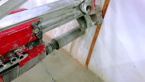 Coring-machine-drilling-a-core-in-a-concrete-wall-to-make-opening